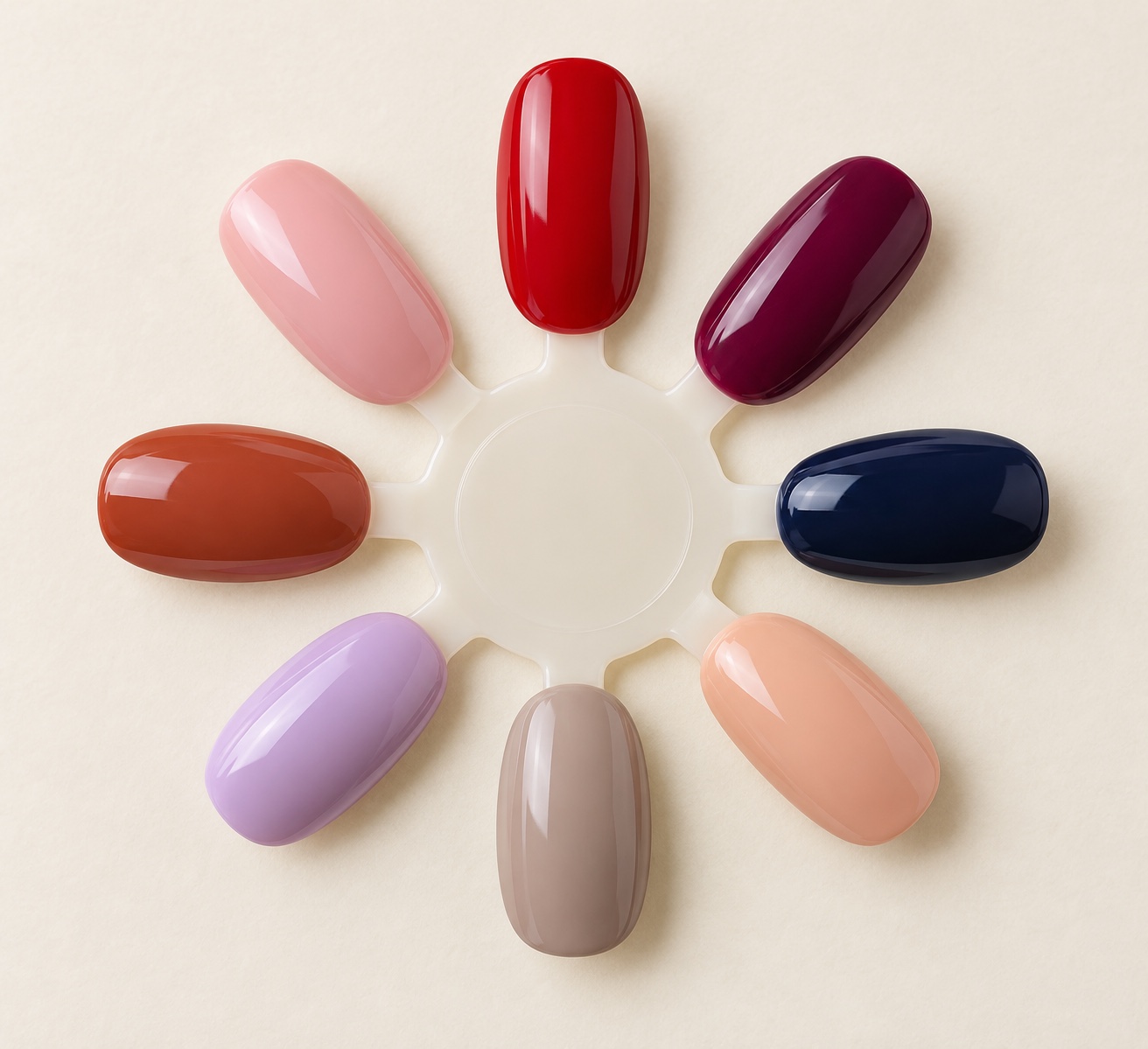 Eight nail polish swatches in ballet pink, crimson, berry, navy, peach nude, taupe, lavender, and terracotta